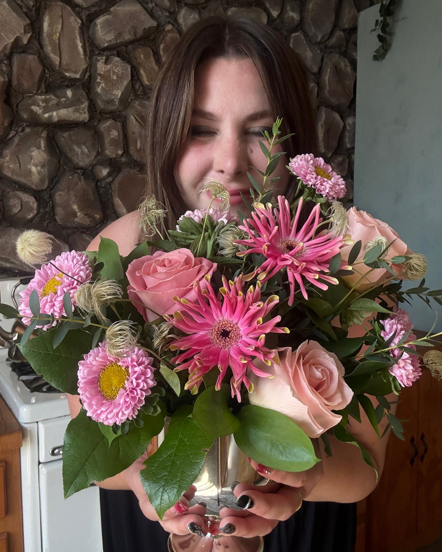 arrangement and woman smelling florals