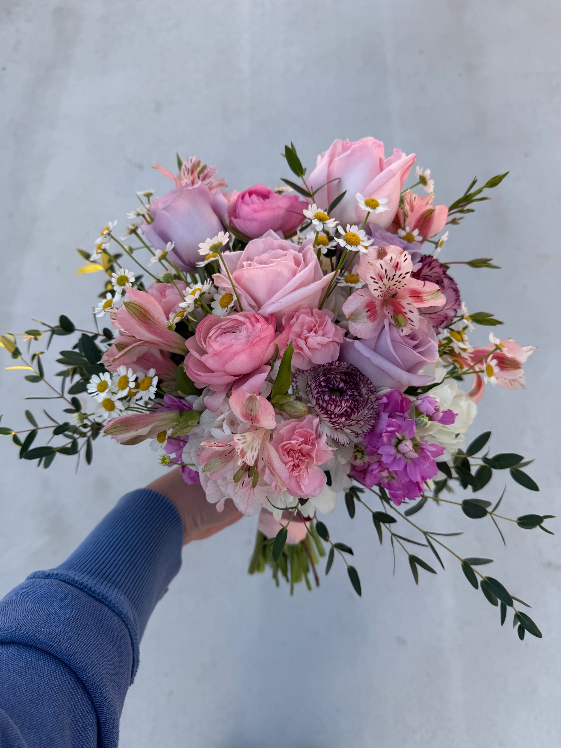 garden style bridal bouquet created with garden roses, ranunculus, hydrangea, stock, chamomile, greenery