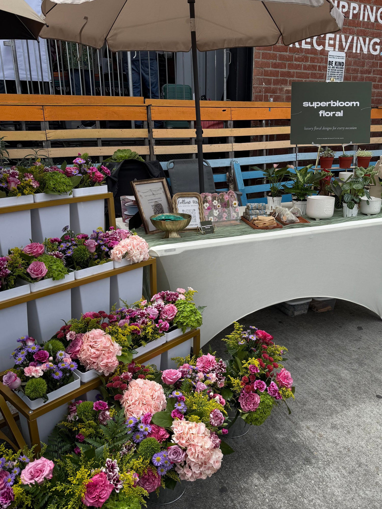 Superbloom Floral flower bar, flower cart experience. Flower cart with colorful bouquets, table with linens and assorted plants and floral needs.