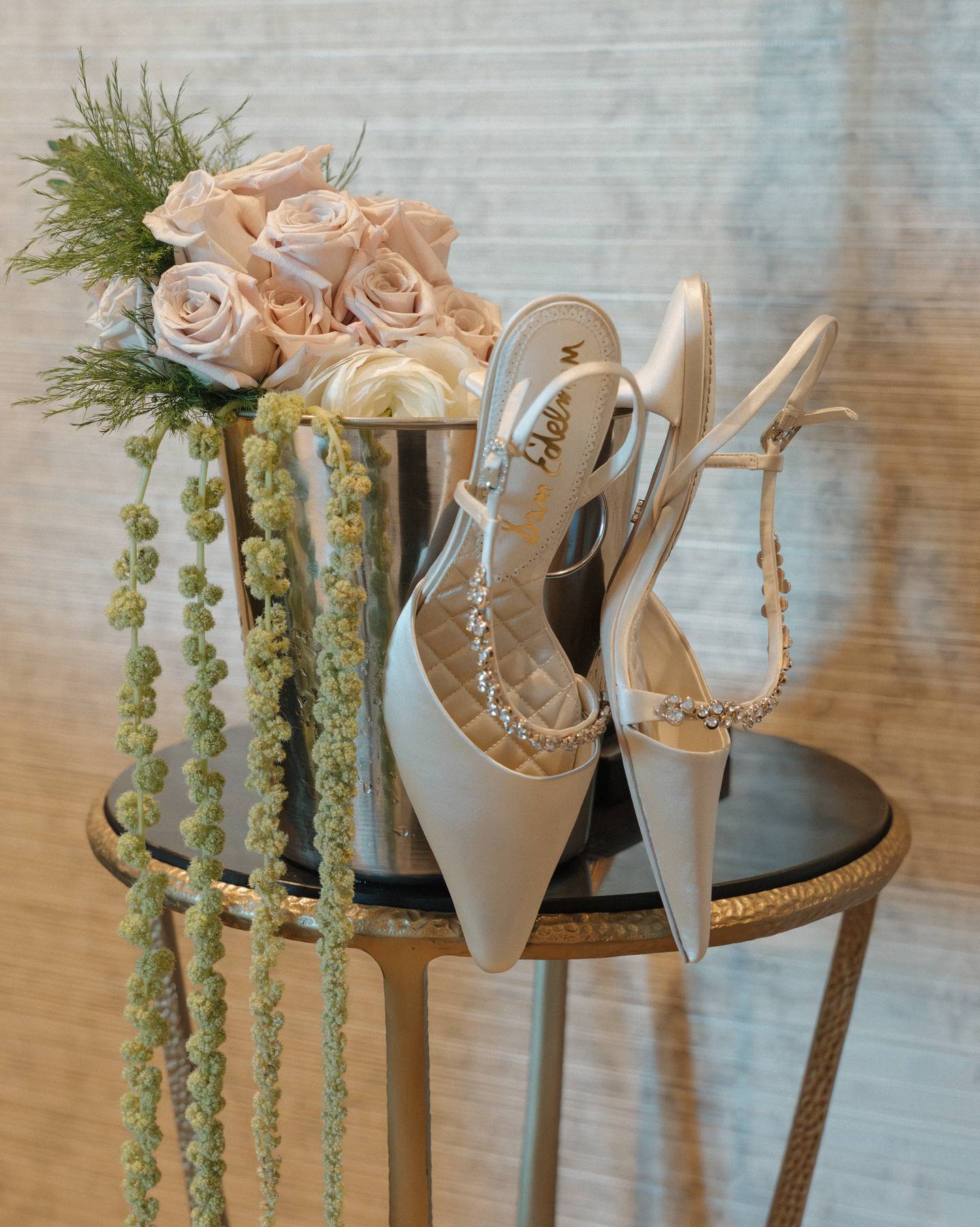 Superbloom Floral Maid of Honor bouquet in a bucket with Bride shoes. Maid of Honor bouquet crafted with roses, ranunculus, and amaranthus. 