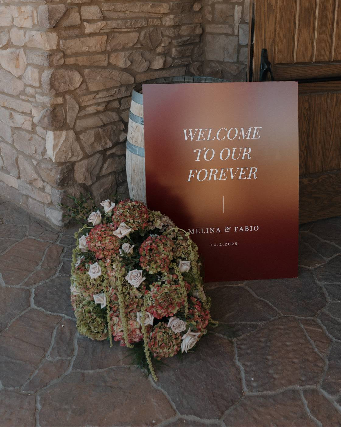 Superbloom Floral Welcome sign floral arrangement crafted with vintage hydrangea, roses, amaranthus, and greens. 