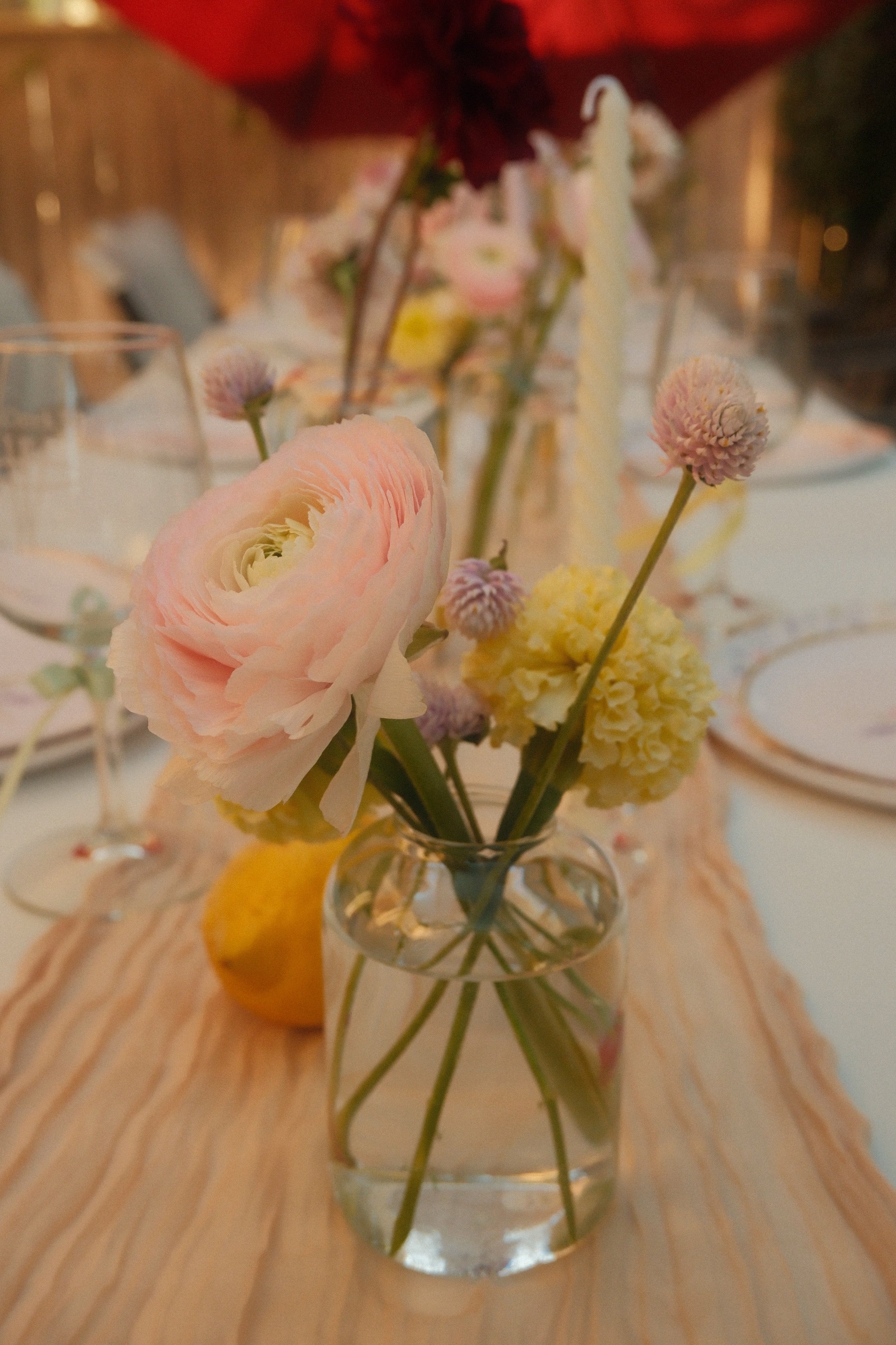 Floral arrangement in a glass vase on a table with a blurred background