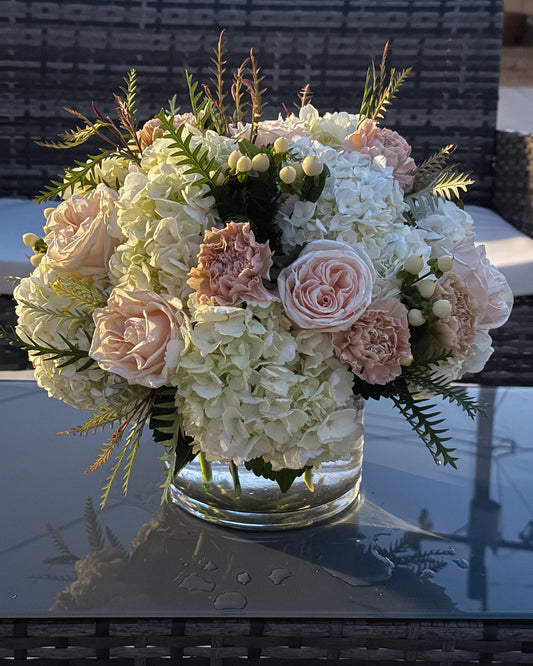 Superbloom Floral, Southern California Mobile Flower Shop bouquet of flowers in a clear vase on a reflective surface with a blurred background