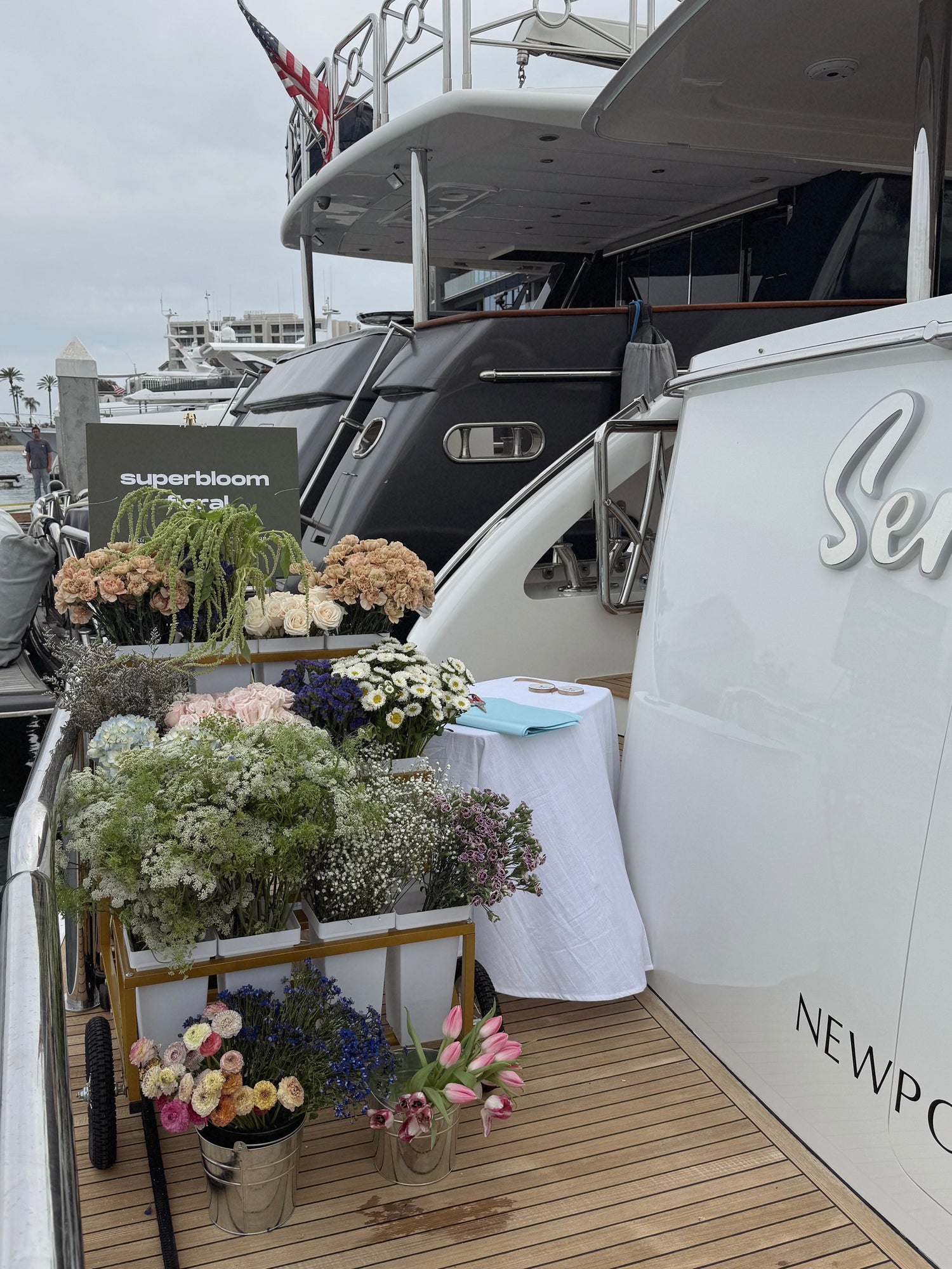 Superbloom Floral flower bar on a yacht for the NBIBS preview. Floral cart filled with flowers. 