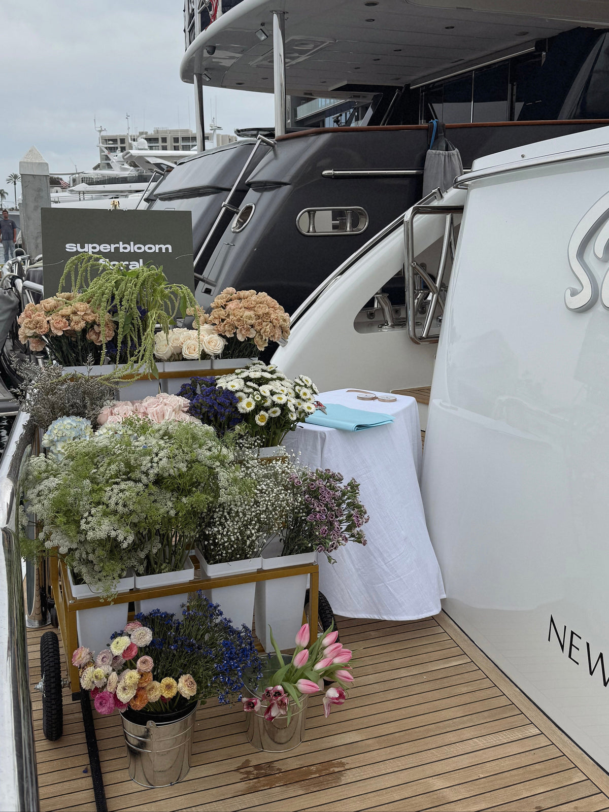 Superbloom Floral flower bar on a yacht for the NBIBS preview. Floral cart filled with flowers. 