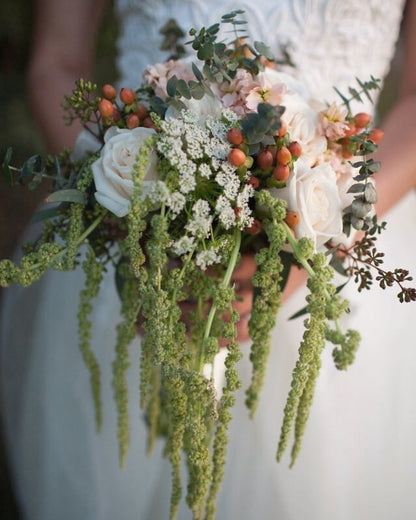 Bouquet of flowers held by a person, with a blurred background