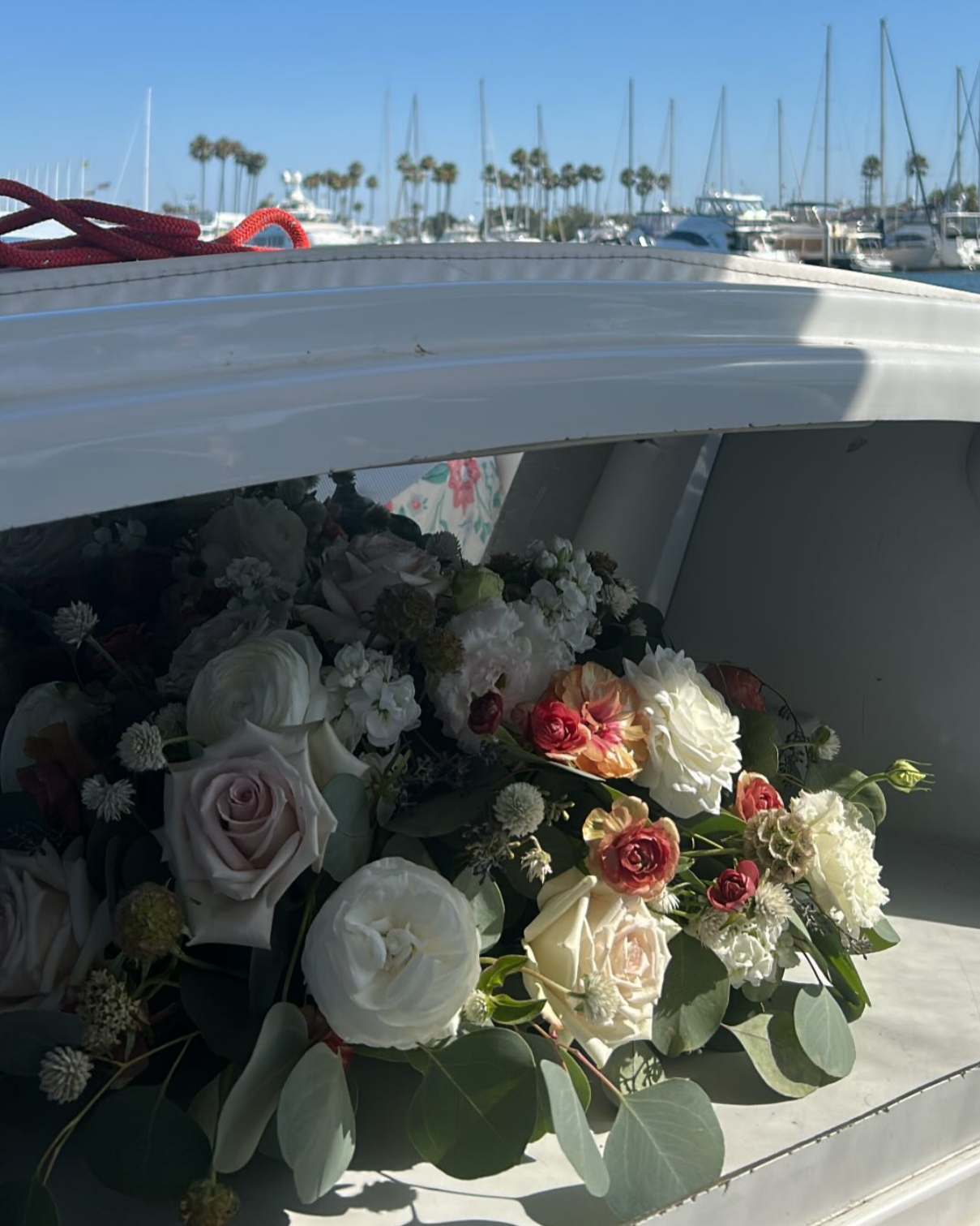 Bouquet of flowers on a boat with a marina in the background